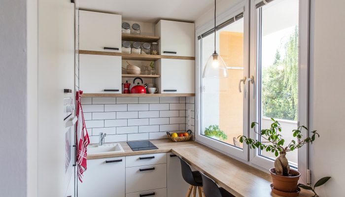 White tiny modern kitchen with red components, reconstruction, cosy small panel house in Prague, Czech Republic; Shutterstock ID 1139077133; ISBN / Project Code: -; Project Title: -; Line of Business: -; Invoice Administrator Name: -